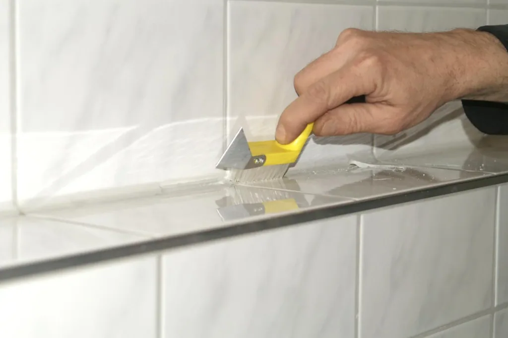 Joint knife with double-sided cutting blade and cleaning brush